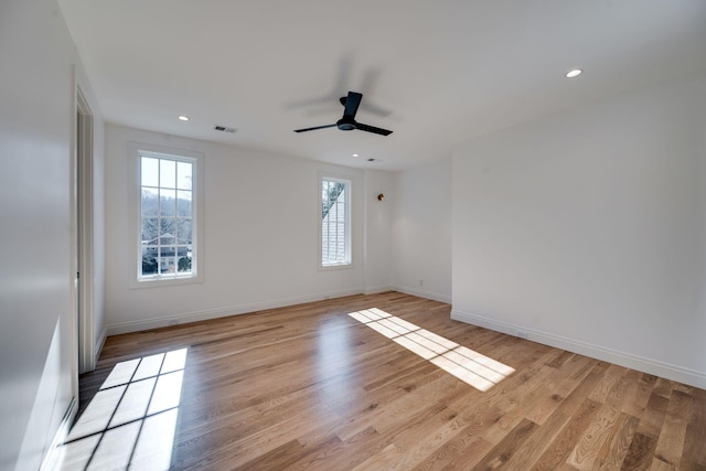 unfurnished room with ceiling fan and light wood-type flooring