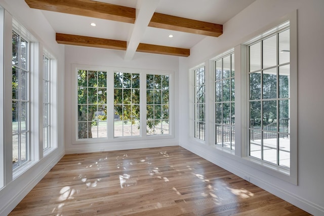 unfurnished sunroom with a healthy amount of sunlight and beam ceiling