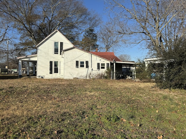 back of house with a carport