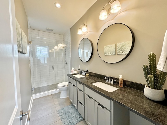 bathroom featuring tile patterned floors, vanity, an enclosed shower, and toilet