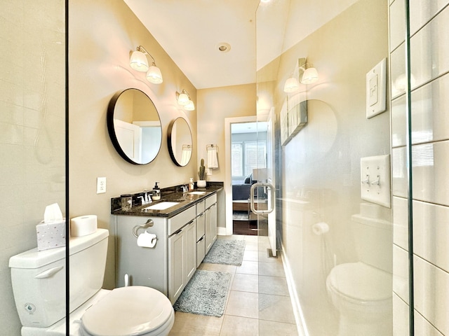 bathroom with tile patterned flooring, vanity, and toilet