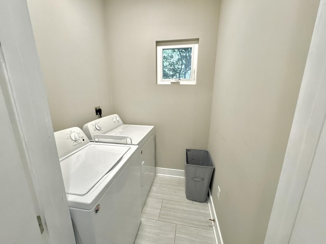 clothes washing area featuring independent washer and dryer