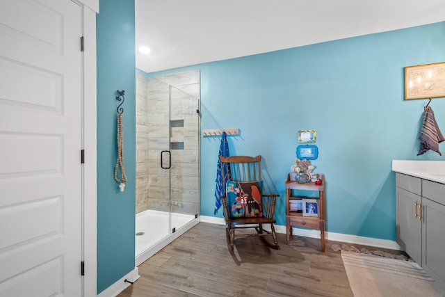 bathroom with vanity, wood-type flooring, and a shower with shower door