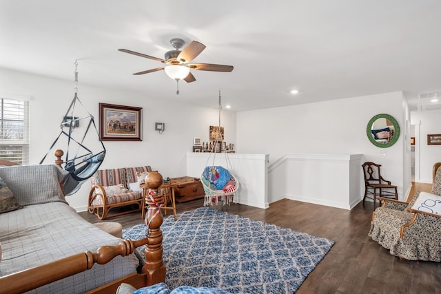 living room with ceiling fan and dark wood-type flooring