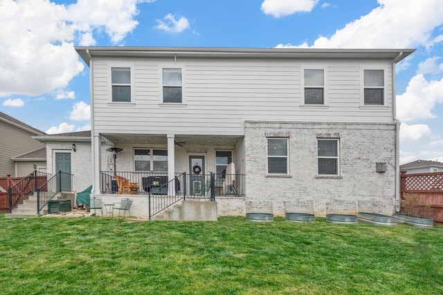 rear view of property with a yard