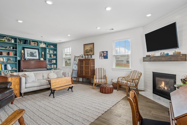 living room featuring a fireplace, hardwood / wood-style floors, and a wealth of natural light