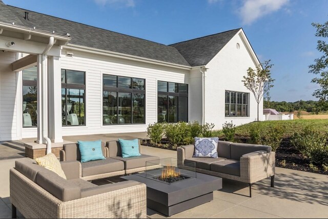 view of patio featuring an outdoor living space with a fire pit