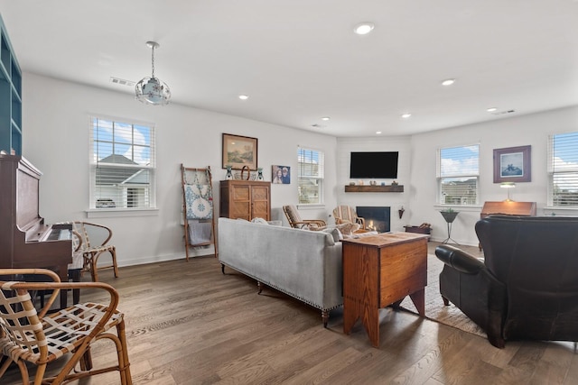 living room featuring a wealth of natural light and dark hardwood / wood-style flooring