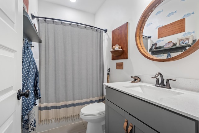 bathroom featuring tile patterned flooring, vanity, and toilet