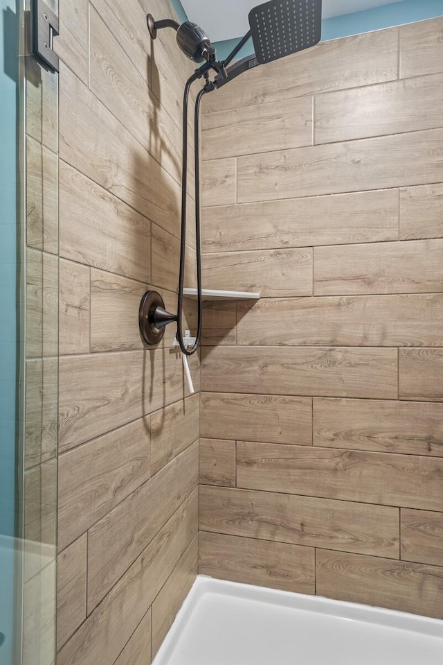 bathroom with a tile shower