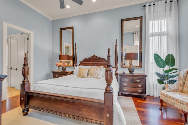 bedroom featuring hardwood / wood-style floors, ceiling fan, and ornamental molding