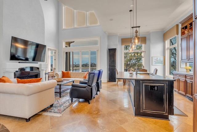 living room with sink, a towering ceiling, and beverage cooler