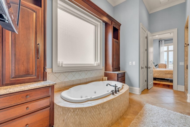 bathroom with tiled bath, tile patterned floors, crown molding, and vanity