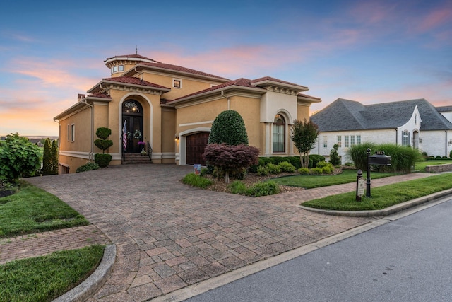 mediterranean / spanish-style home with a garage