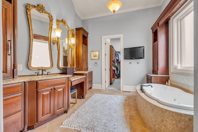 bathroom with tile patterned floors, crown molding, vanity, and a relaxing tiled tub