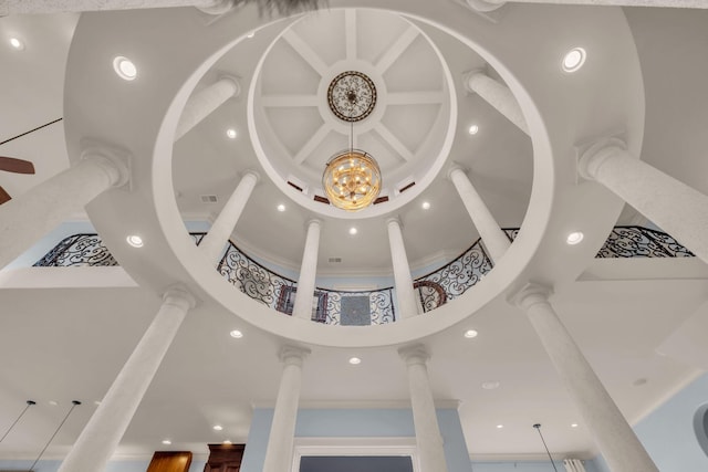 details with coffered ceiling, crown molding, and decorative columns