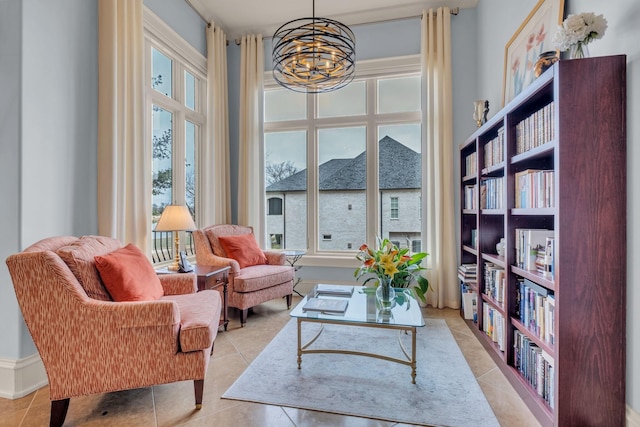 living area with a notable chandelier and light tile patterned floors