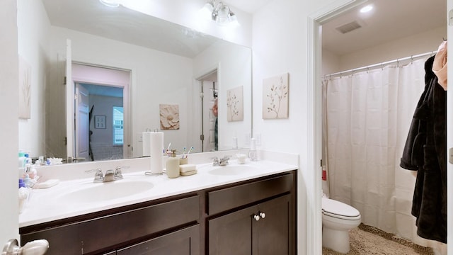 bathroom with a shower with curtain, vanity, and toilet