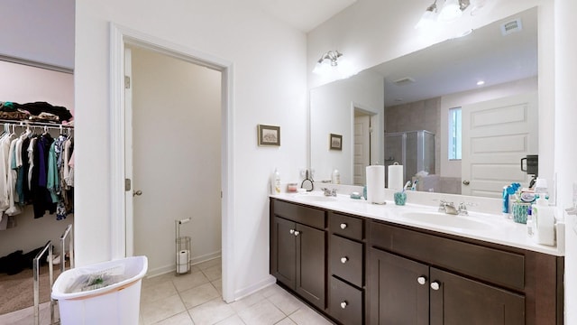 bathroom with vanity, tile patterned floors, and a shower with shower door