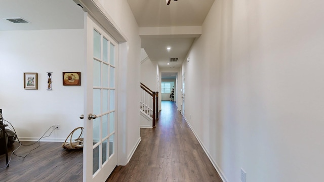 hallway featuring french doors and dark wood-type flooring