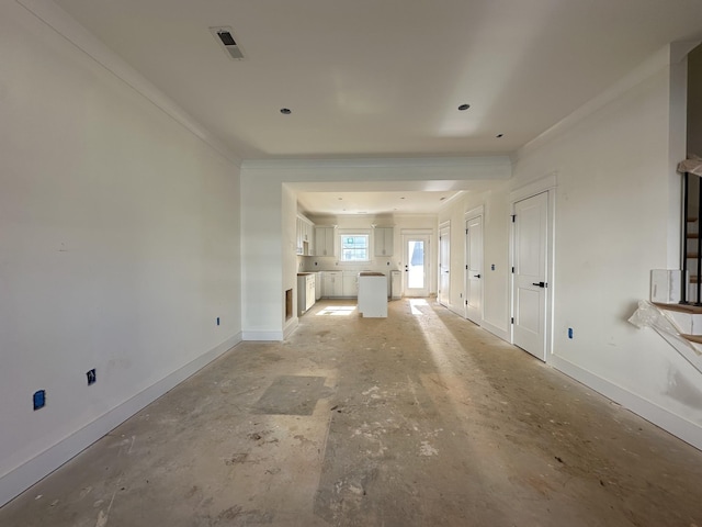 unfurnished living room with ornamental molding