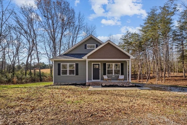 view of front of home with covered porch and a front yard