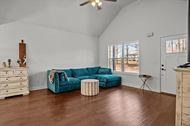 living area with ceiling fan, dark wood-type flooring, and high vaulted ceiling