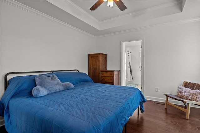 bedroom with dark hardwood / wood-style flooring, ensuite bath, ceiling fan, and crown molding