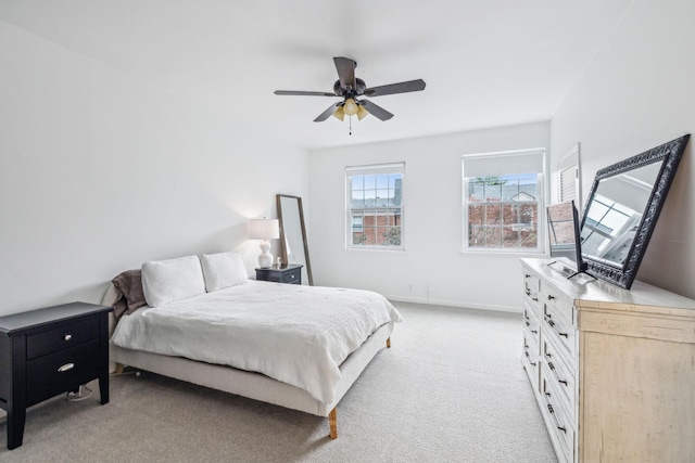 bedroom with ceiling fan and light carpet