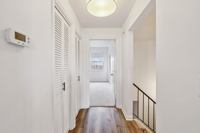 hallway with hardwood / wood-style flooring