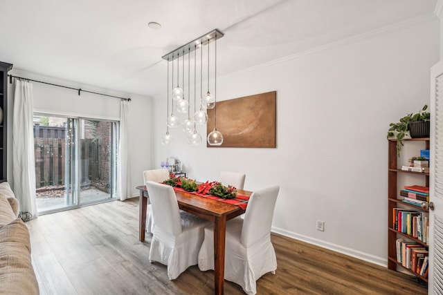 dining room with dark hardwood / wood-style floors and ornamental molding