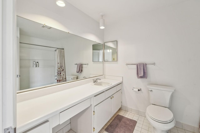 bathroom featuring tile patterned floors, vanity, and toilet