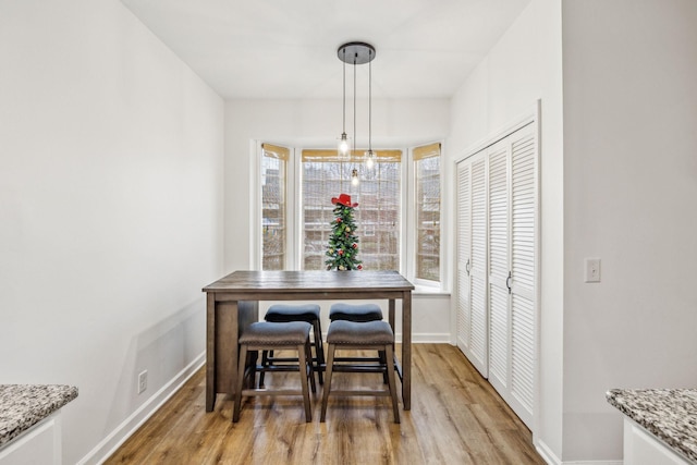 dining space featuring light wood-type flooring