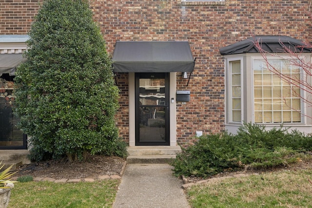 entrance to property with brick siding