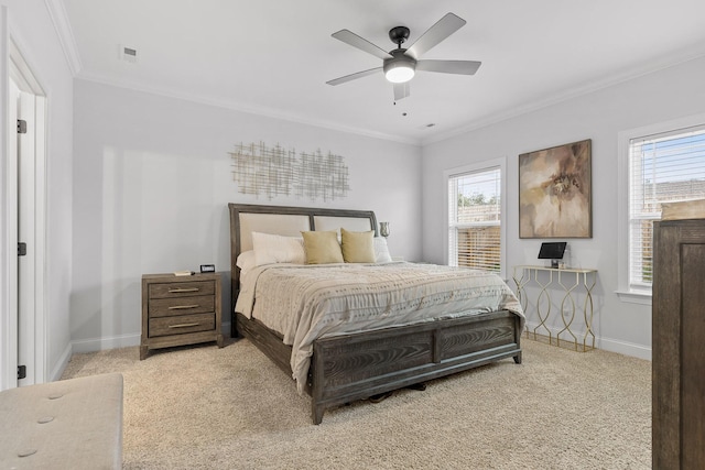 carpeted bedroom with multiple windows, ceiling fan, and ornamental molding