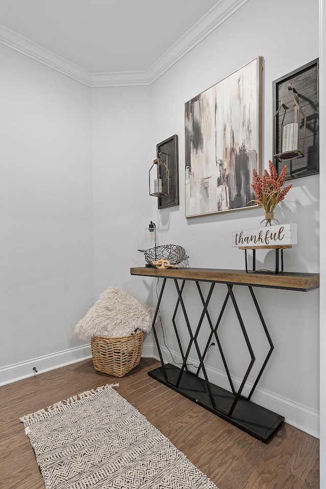 sitting room with hardwood / wood-style floors and ornamental molding