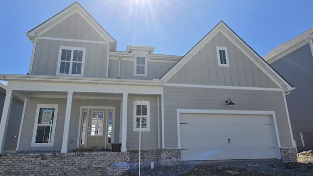 craftsman-style house featuring a porch, board and batten siding, and an attached garage