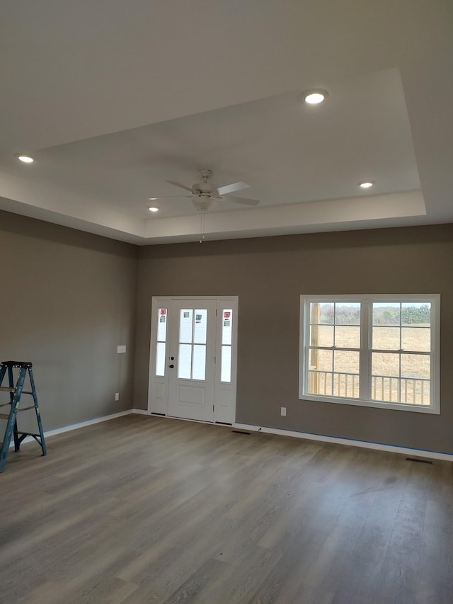 empty room with ceiling fan and wood-type flooring