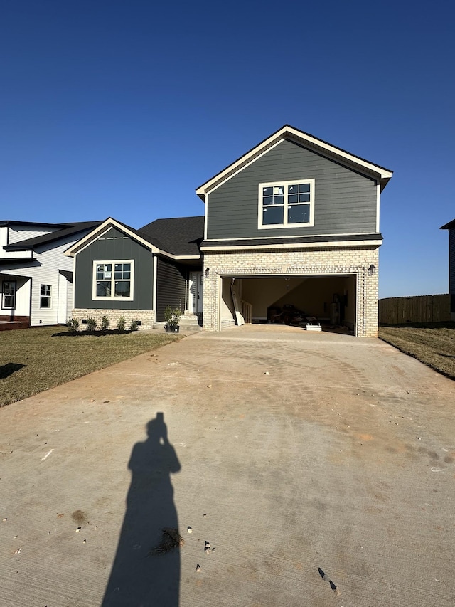 traditional home featuring brick siding, driveway, and a garage