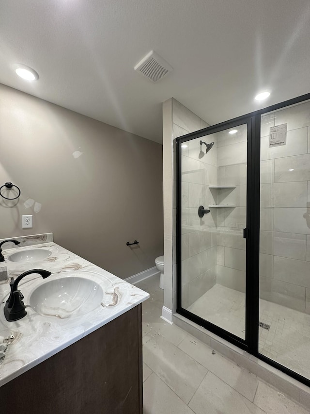 full bathroom featuring a stall shower, toilet, visible vents, and a sink