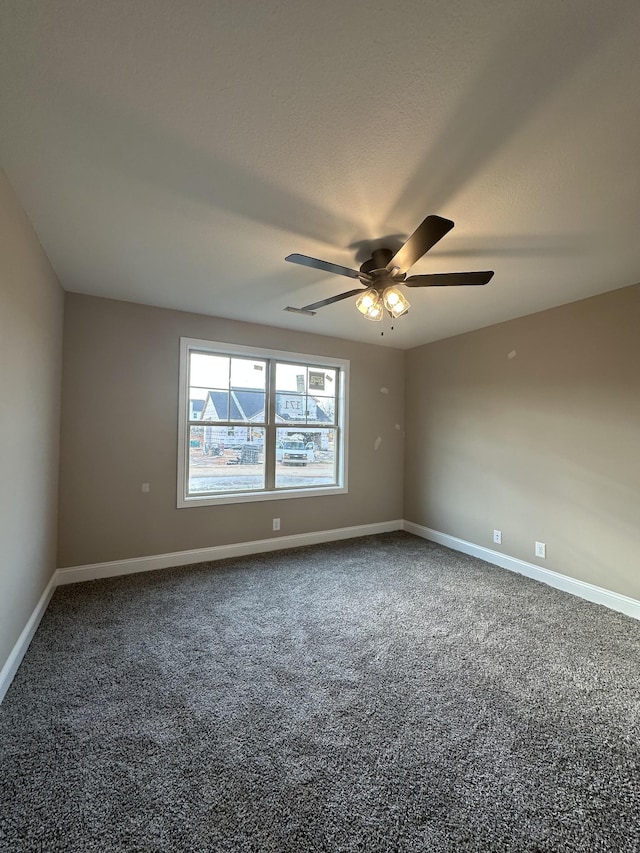 empty room featuring carpet flooring, a ceiling fan, baseboards, and a textured ceiling