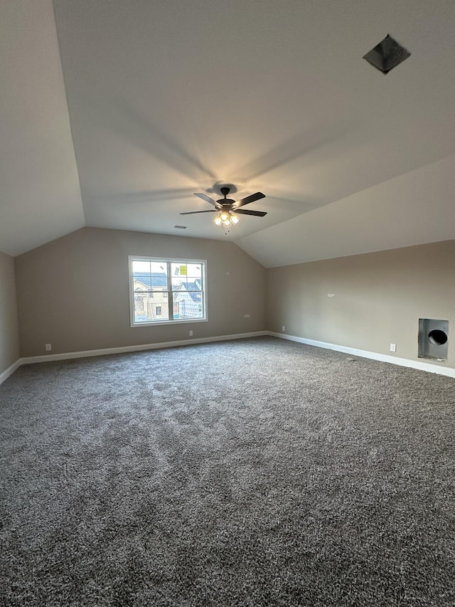 additional living space featuring carpet flooring, ceiling fan, baseboards, and lofted ceiling