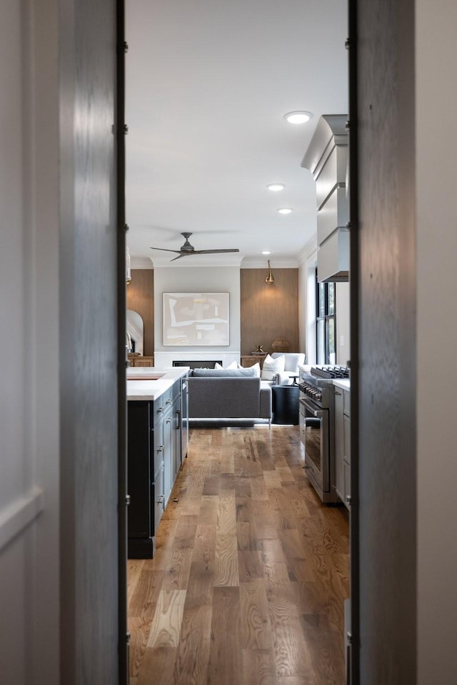 corridor with crown molding and light hardwood / wood-style flooring