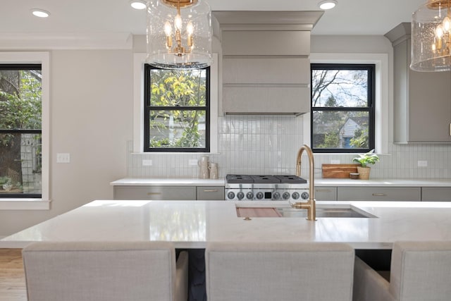 kitchen with tasteful backsplash, sink, gray cabinets, and plenty of natural light