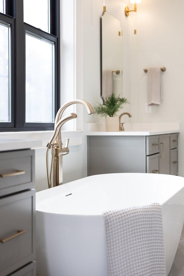 bathroom featuring vanity and a bath