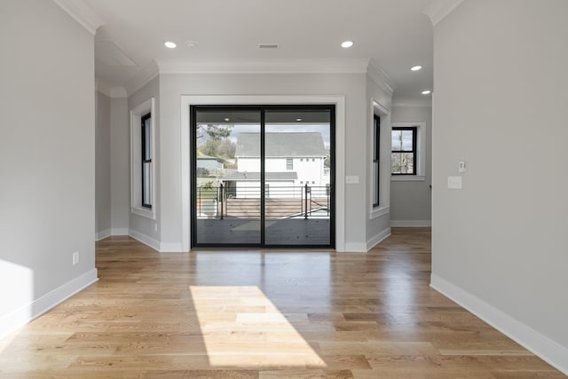 interior space featuring crown molding and light wood-type flooring