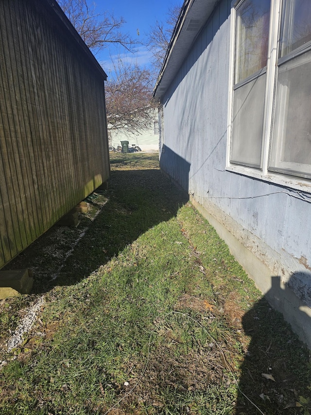 view of side of property with a yard