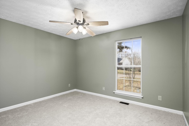 empty room with carpet, a textured ceiling, and ceiling fan