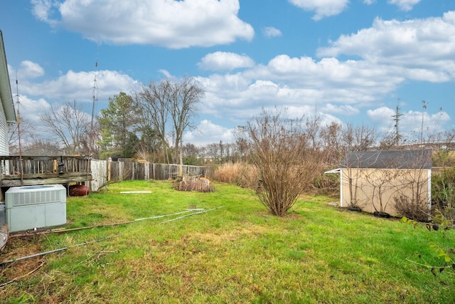 view of yard featuring central AC and a wooden deck