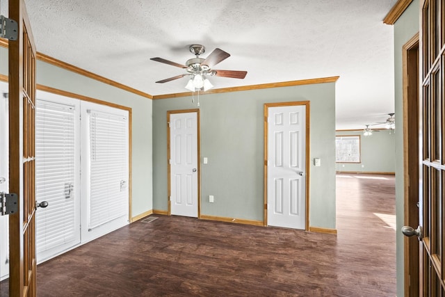 unfurnished bedroom with a textured ceiling, dark hardwood / wood-style flooring, ceiling fan, and ornamental molding